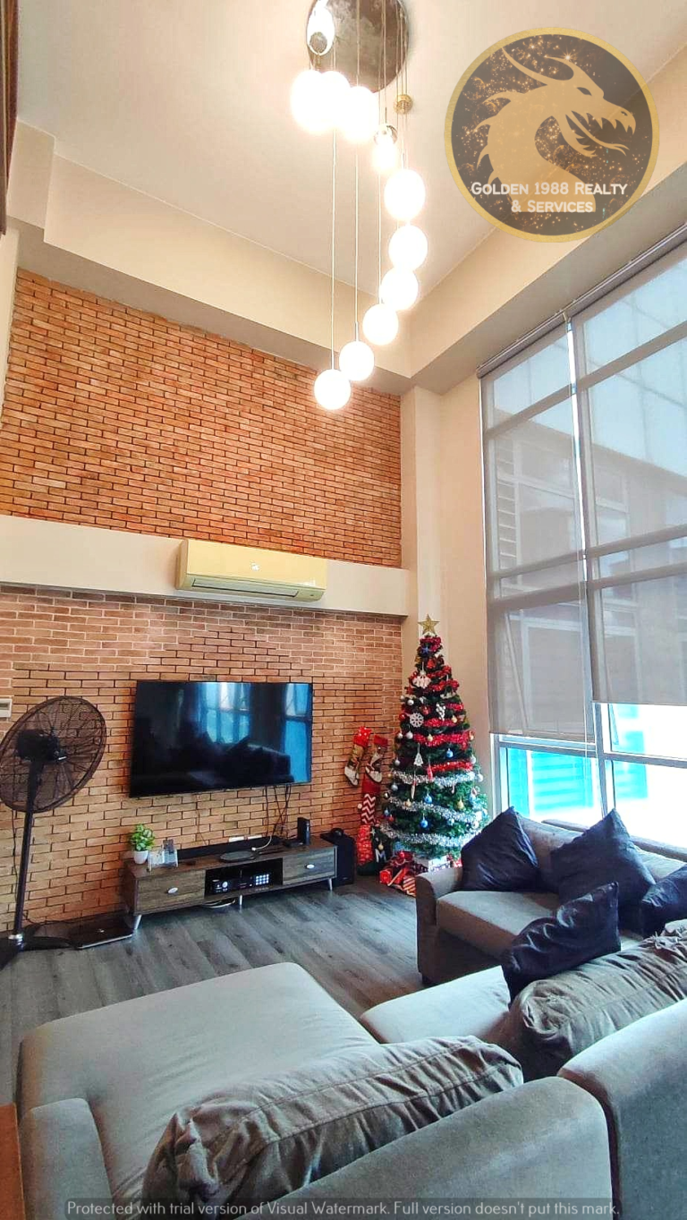 Living room in fully furnished 2 bedroom loft unit in Legrand 3